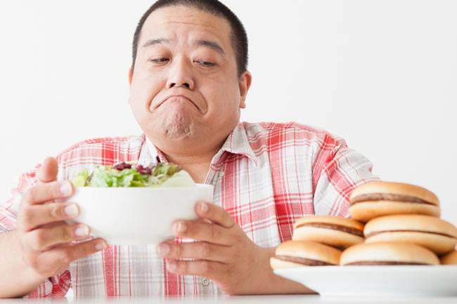 Man Deciding Salad Or Burgers Healthy Eating